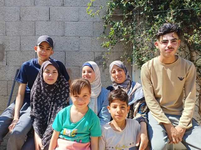 Fadi Al-Kahlout, a top Palestinian student, pictured with his family, awaiting safe passage to Libya to pursue a scholarship in dentistry with the support of The Children’s Future.